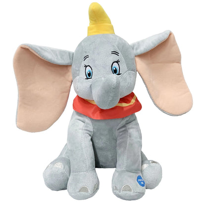 Peluche morbido e musicale di Disney Dumbo grigio con grandi orecchie rosa, collarino rosso e giallo e un pulsante blu "Press Me" sulla zampa
