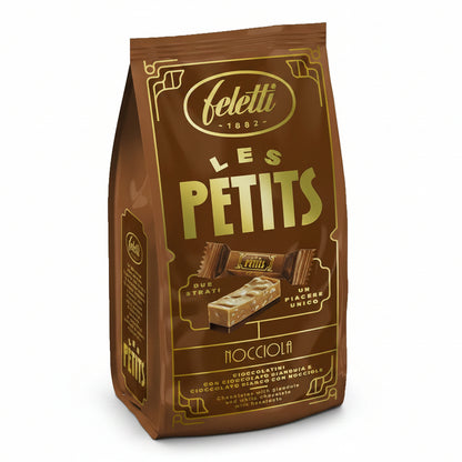 Confezione marrone e oro di cioccolatini Feletti Les Petits Nocciola con grafica dei due strati di cioccolato gianduja e bianco con nocciole su sfondo bianco