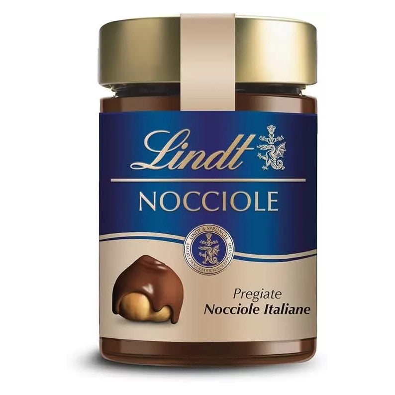Vasetto di vetro di crema spalmabile Lindt Nocciole con etichetta blu e beige con nocciola ricoperta di cioccolato su sfondo bianco