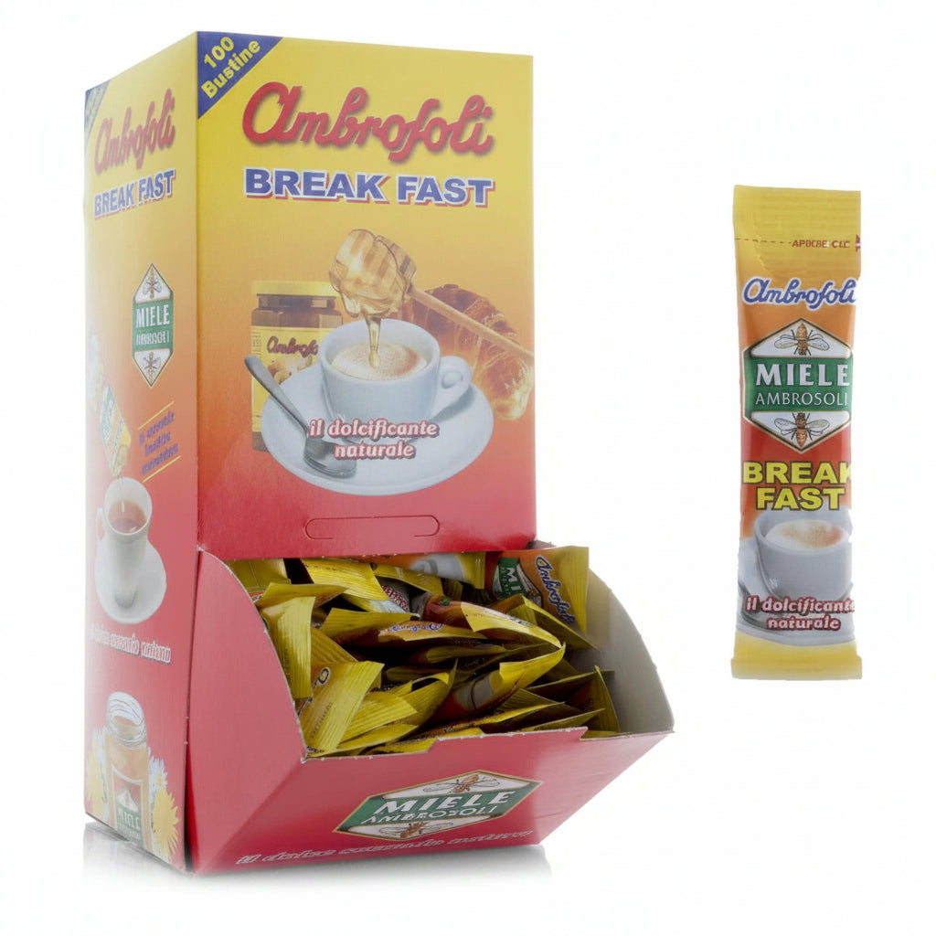 Box dispenser giallo e rosso di Miele Ambrofoli Break Fast con 100 bustine monodose e una bustina singola affiancata su sfondo bianco
