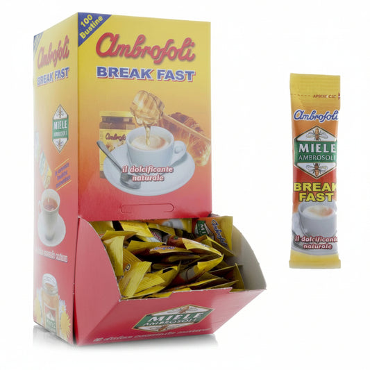 Box dispenser giallo e rosso di Miele Ambrofoli Break Fast con 100 bustine monodose e una bustina singola affiancata su sfondo bianco