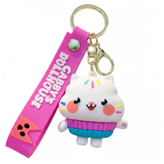 Portachiavi in gomma fucsia e bianca Gabby's Dollhouse con il personaggio Cakey Cat a forma di tortina, anello e moschettone dorati su sfondo bianco