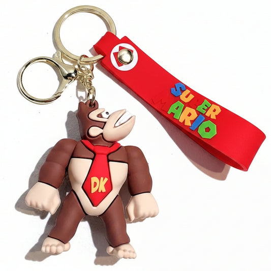 Portachiavi 3D di Donkey Kong da Super Mario in silicone rosso e marrone con figura del personaggio e cordino con scritta Super Mario su sfondo bianco