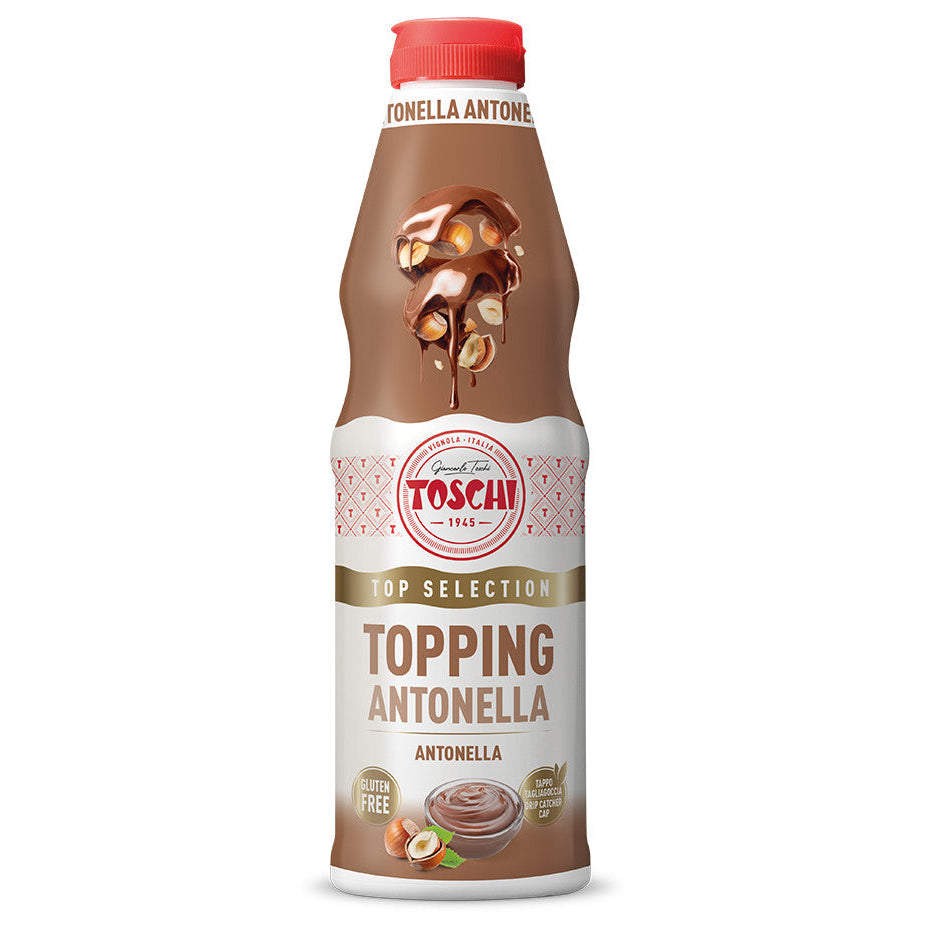 Flacone marrone e bianco di Topping Top Selection Antonella Toschi al gusto nocciola con tappo rosso e nocciole su sfondo bianco