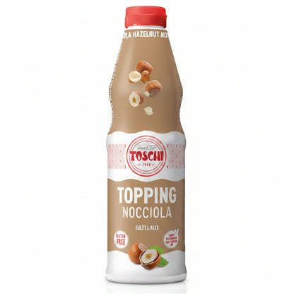 Flacone beige e bianco di Topping Nocciola Toschi con tappo rosso, nocciole intere e sbucciate su sfondo bianco
